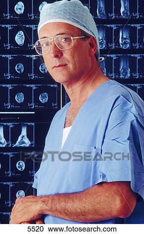 Surgeon with MRI scans View Large Photo Image Stock Image - Surgeon with MRI scans. Fotosearch