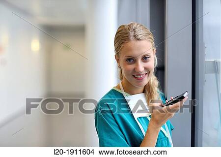 Picture - surgeon with smartphone in the operating room hallway, Onkologikoa Hospital, Oncology Institute, Case Center for prevention, diagnosis and treatment of cancer, Donostia, San Sebastian, Gipuzkoa, Basque Country, Spain. Fotosearch