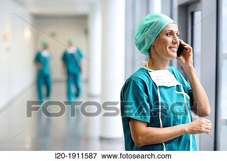 Stock Photo - surgeon with smartphone in the operating room hallway, Onkologikoa Hospital, Oncology Institute, Case Center for prevention, diagnosis and treatment of cancer, Donostia, San Sebastian, Gipuzkoa, Basque Country, Spain. Fotosearch