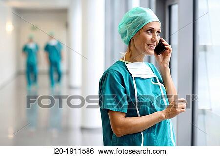 Stock Photograph - surgeon with smartphone in the operating room hallway, Onkologikoa Hospital, Oncology Institute, Case Center for prevention, diagnosis and treatment of cancer, Donostia, San Sebastian, Gipuzkoa, Basque Country, Spain. Fotosearch