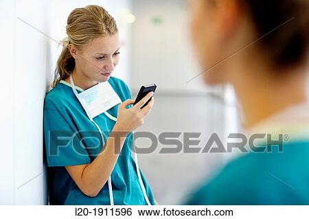 Stock Photograph - surgeon with smartphone in the operating room hallway, Onkologikoa Hospital, Oncology Institute, Case Center for prevention, diagnosis and treatment of cancer, Donostia, San Sebastian, Gipuzkoa, Basque Country, Spain. Fotosearch