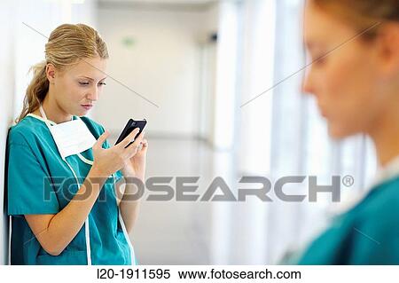 Stock Photography - surgeon with smartphone in the operating room hallway, Onkologikoa Hospital, Oncology Institute, Case Center for prevention, diagnosis and treatment of cancer, Donostia, San Sebastian, Gipuzkoa, Basque Country, Spain. Fotosearch