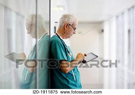 Stock Photography - surgeon with tablet in the operating room hallway, Onkologikoa Hospital, Oncology Institute, Case Center for prevention, diagnosis and treatment of cancer, Donostia, San Sebastian, Gipuzkoa, Basque Country, Spain. Fotosearch