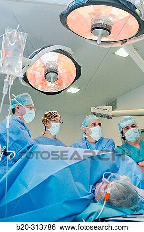 Stock Photograph - Surgeons at laparoscopy operating room of hospital. Fotosearch