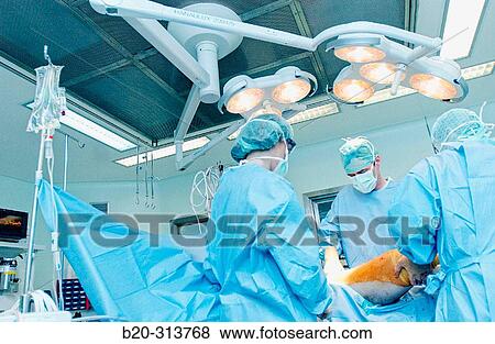 Stock Photo - Surgeons at traumatology operating room of hospital. Fotosearch
