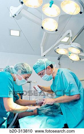 Surgeons during hearing operation at otorhinolaryngology operating room of hospital View Large Photo Image Stock Image - Surgeons during hearing operation at otorhinolaryngology operating room of hospital. Fotosearch