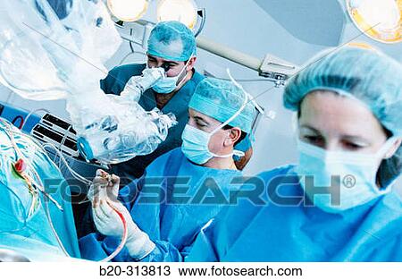 Surgeons during hearing operation at otorhinolaryngology operating room of hospital View Large Photo Image Stock Image - Surgeons during hearing operation at otorhinolaryngology operating room of hospital. Fotosearch