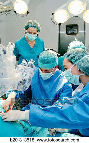 Stock Photo - Surgeons during hearing operation at otorhinolaryngology operating room of hospital. Fotosearch