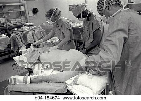 Surgeons preparing patient for operation View Large Photo Image Picture - Surgeons preparing patient for operation. Fotosearch