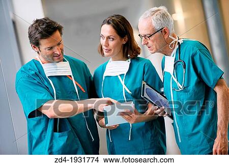 Picture - Surgeons with tablet in the operating room hallway, Onkologikoa Hospital, Oncology Institute, Case Center for prevention, diagnosis and treatment of cancer, Donostia, San Sebastian, Gipuzkoa, Basque Country, Spain. Fotosearch