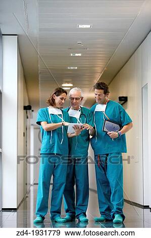 Stock Photo - Surgeons with tablet in the operating room hallway, Onkologikoa Hospital, Oncology Institute, Case Center for prevention, diagnosis and treatment of cancer, Donostia, San Sebastian, Gipuzkoa, Basque Country, Spain. Fotosearch