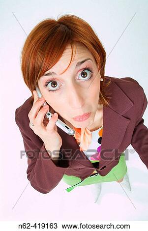 Surprised girl with red hair answered the phone View Large Photo Image Stock Image - Surprised girl with red hair answered the phone. Fotosearch