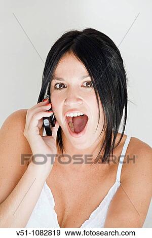Surprised woman on the phone View Large Photo Image Stock Photo - Surprised woman on the phone. Fotosearch