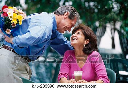 surprising her with flowers at outdoor cafe View Large Photo Image Stock Image - surprising her with flowers at outdoor cafe. Fotosearch