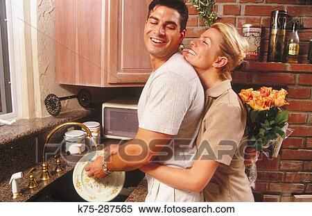 surprising him with flowers while he's doing dishes View Large Photo Image Stock Photography - surprising him with flowers while he's doing dishes. Fotosearch
