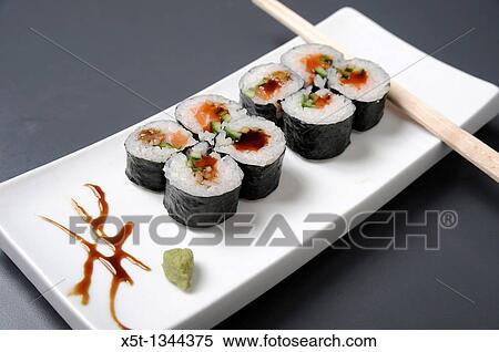 Stock Photography - Sushi on a platter with chopsticks. Fotosearch