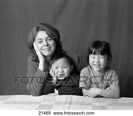 Stock Photo - Swedish mother with chinese adopted children. Fotosearch