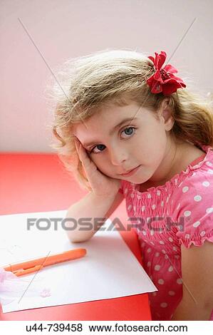 Sweet girl stops doing her homework View Large Photo Image Stock Photo - Sweet girl stops doing her homework. Fotosearch