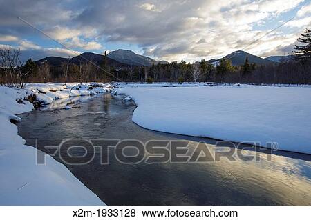 Swift River during the winter months in Albany, New Hampshire USA. This river travels along side of the Kancamagus Scenic Byway, which is one of New England's scenic byways. Mount Passaconaway is off in the distance View Large Photo Image Stock Photo - Swift River during the winter months in Albany, New Hampshire USA. This river travels along side of the Kancamagus Scenic Byway, which is one of New England's scenic byways. Mount Passaconaway is off in the distance. Fotosearch
