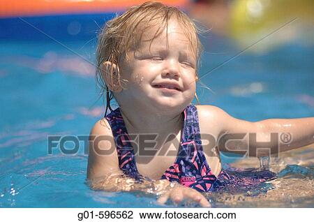 Swiming in a back yard pool View Large Photo Image Stock Image - Swiming in a back yard pool. Fotosearch