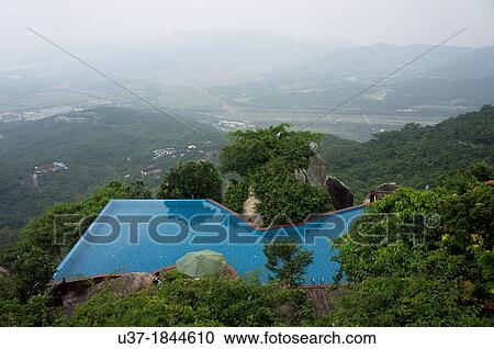 Swimming pool on hilltop at Yalong Bay Tropical Paradise Forest Park, Hainan Island, China. View Large Photo Image Stock Image - Swimming pool on hilltop at Yalong Bay Tropical Paradise Forest Park, Hainan Island, China.. Fotosearch
