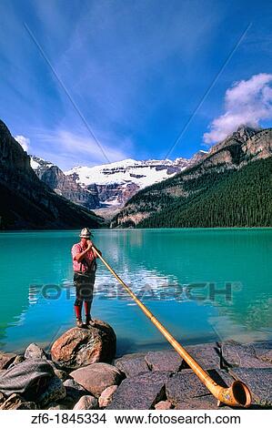 Swiss Alphorn player at Lake Louise in Banff Canada View Large Photo Image Picture - Swiss Alphorn player at Lake Louise in Banff Canada. Fotosearch