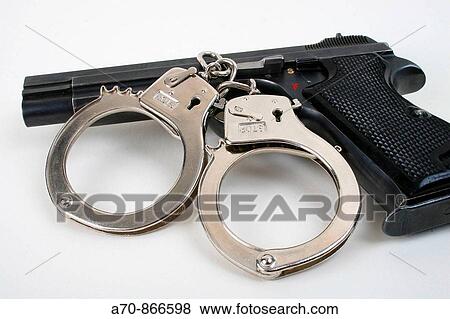 Swiss army pistol and handcuffs View Large Photo Image Stock Photo - Swiss army pistol and handcuffs. Fotosearch