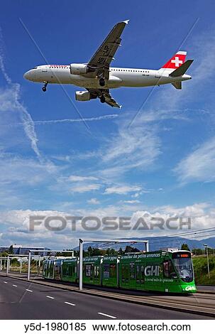 Swiss passenger jet liner flying over tram in Geneva, Geneva, Switzerland, Europe View Large Photo Image Stock Photography - Swiss passenger jet liner flying over tram in Geneva, Geneva, Switzerland, Europe. Fotosearch