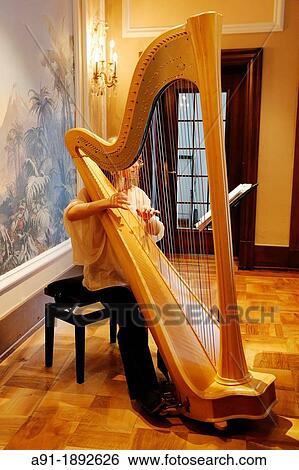 Switzerland, The Graubunden canton, Saint-Moritz, Historic and luxury hotel Badrutt Palace, harp musician Marta Kaszap during breakfast View Large Photo Image Stock Photograph - Switzerland, The Graubunden canton, Saint-Moritz, Historic and luxury hotel Badrutt Palace, harp musician Marta Kaszap during breakfast. Fotosearch