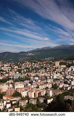 Stock Image - Switzerland, Ticino, Lake Lugano, Lugano, high angle town view from Monte Bre, morning. Fotosearch