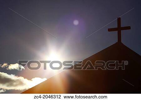 Stock Image - Symbolic sun and chapel with wooden cross.. Fotosearch
