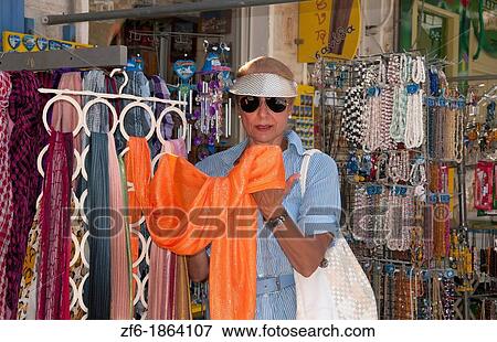 Syros Greece Islands, Hermoupolis city center shopping tourist woman looking for sales to buy souvenirs and relax View Large Photo Image Stock Photo - Syros Greece Islands, Hermoupolis city center shopping tourist woman looking for sales to buy souvenirs and relax. Fotosearch