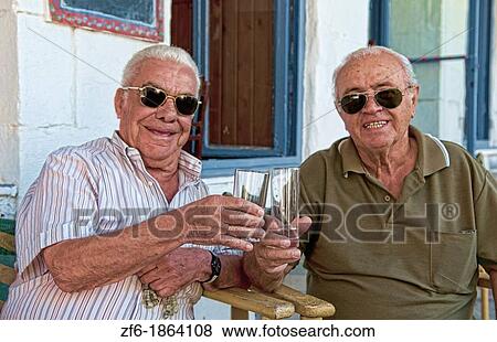 Stock Photo - Syros Greece Islands, Hermoupolis city center coffee as good friends buddies meet old men locals to relax. Fotosearch