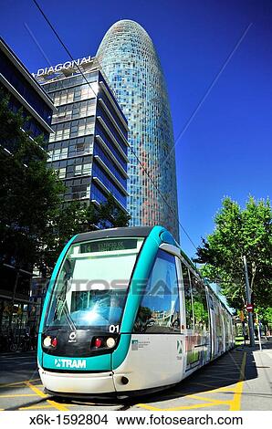Picture - T4 Trambes's light rail tram, Agbar Tower in background, architect Jean Nouvel, distrito 22@, Barcelona, Catalonia, Spain. Fotosearch