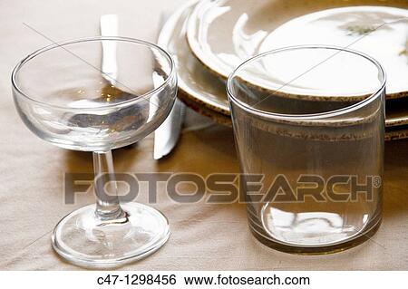 Table set with plates, cups, glasses, cover, tablecloth, spoons, forks and knives View Large Photo Image Stock Photograph - Table set with plates, cups, glasses, cover, tablecloth, spoons, forks and knives. Fotosearch