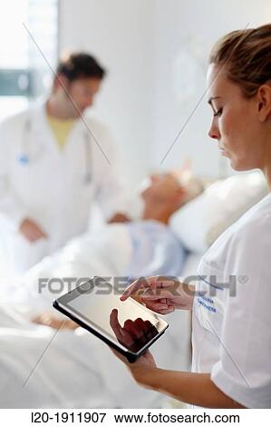 Tablet nurse in hospital room, Onkologikoa Hospital, Oncology Institute, Case Center for prevention, diagnosis and treatment of cancer, Donostia, San Sebastian, Gipuzkoa, Basque Country, Spain View Large Photo Image Stock Photo - Tablet nurse in hospital room, Onkologikoa Hospital, Oncology Institute, Case Center for prevention, diagnosis and treatment of cancer, Donostia, San Sebastian, Gipuzkoa, Basque Country, Spain. Fotosearch