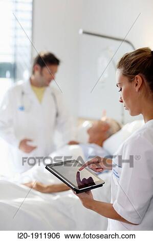 Stock Photograph - Tablet nurse in hospital room, Onkologikoa Hospital, Oncology Institute, Case Center for prevention, diagnosis and treatment of cancer, Donostia, San Sebastian, Gipuzkoa, Basque Country, Spain. Fotosearch