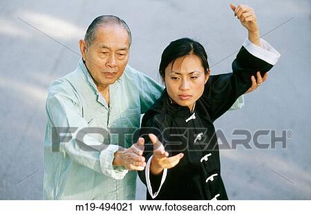 Stock Image - tai chi instructor teaching female student. Fotosearch