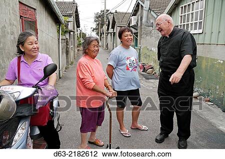 TAIWAN. American missionary priest visiting retired KMT soldiers and their families at Chang Chyu village, Taichung. View Large Photo Image Stock Image - TAIWAN. American missionary priest visiting retired KMT soldiers and their families at Chang Chyu village, Taichung.. Fotosearch