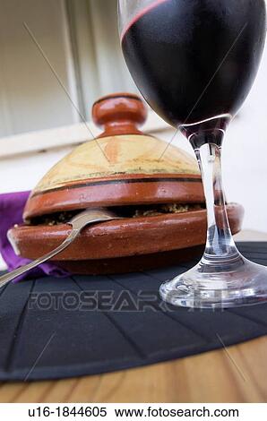 Tajin Arab dish with a glass of wine View Large Photo Image Stock Photography - Tajin Arab dish with a glass of wine. Fotosearch