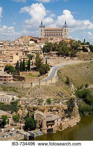 Stock Photograph - Tajo River and Toledo city view with the Alcazar fortress, Toledo. Castilla-La Mancha, Spain. Fotosearch
