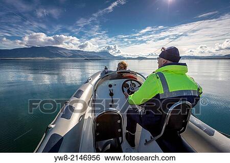 Stock Photograph - Taking a ride in a small boat on Reykjavik Harbor, Iceland.. Fotosearch