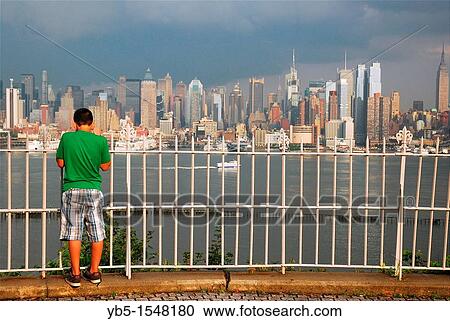 Stock Image - Taking in the Manhattan View. Fotosearch