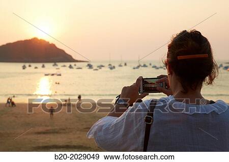 Taking photos. Sunset on the beach of La Concha. Donostia. San Sebastian. Gipuzkoa. Basque Country. Spain. View Large Photo Image Stock Photo - Taking photos. Sunset on the beach of La Concha. Donostia. San Sebastian. Gipuzkoa. Basque Country. Spain.. Fotosearch