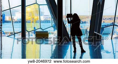 Stock Image - Taking pictures inside The Harpa Concert Hall and Conference Center, Reykjavik, Iceland.. Fotosearch