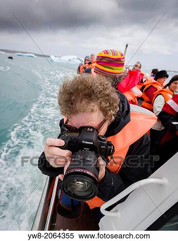 Stock Photography - Taking pictures on a boat trip, Jokulsarlon Glacial Lagoon, Breidamerkurjokull, Vatnajokull Ice Cap, Iceland.. Fotosearch
