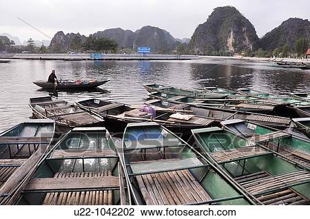 Tam Coc (Vietnam): canoes along the Ngo Dong river View Large Photo Image Stock Image - Tam Coc (Vietnam): canoes along the Ngo Dong river. Fotosearch