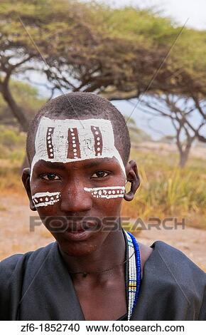Tanzania Serengeti Africa Masai Maasai boys in black from circumcision ceremony with face paint and black clothes 7 View Large Photo Image Stock Image - Tanzania Serengeti Africa Masai Maasai boys in black from circumcision ceremony with face paint and black clothes 7. Fotosearch