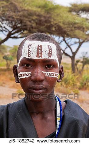 Tanzania Serengeti Africa Masai Maasai boys in black from circumcision ceremony with face paint and black clothes 7 View Large Photo Image Stock Image - Tanzania Serengeti Africa Masai Maasai boys in black from circumcision ceremony with face paint and black clothes 7. Fotosearch