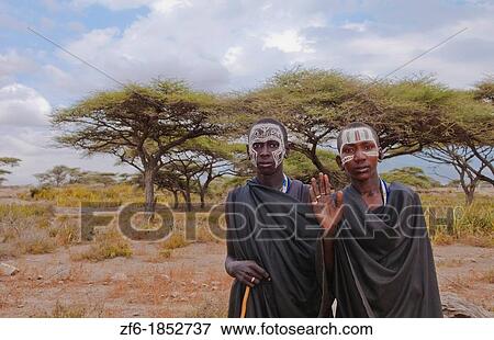 Tanzania Serengeti Africa Masai Maasai boys in black clothes from circumcision ceremony with face paint 7 View Large Photo Image Stock Photo - Tanzania Serengeti Africa Masai Maasai boys in black clothes from circumcision ceremony with face paint 7. Fotosearch